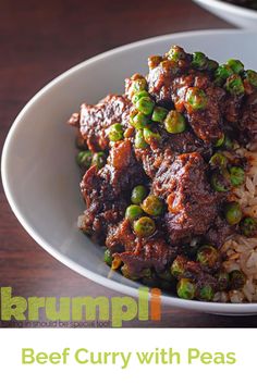 a white bowl filled with beef and peas