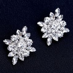 pair of diamond earrings on black background