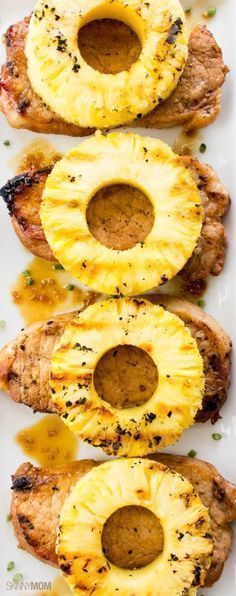 grilled pineapple and pork chops on a white platter