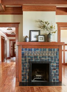 a living room with a fireplace and pictures on the mantle