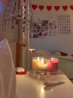 two candles sitting on top of a white table