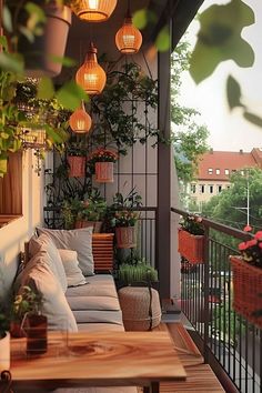 a balcony with lots of potted plants and lights hanging from it's ceiling