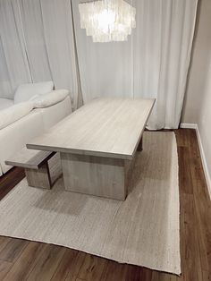 a living room with a couch, table and rug