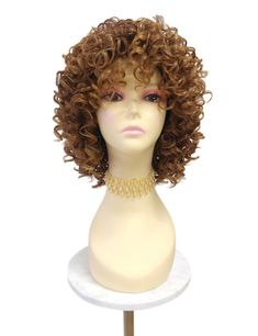 Stylish wig featuring defined spiral curls and bangs. Inside cap has no combs and adjustable elastic straps. Heat-resistant up to 350F. Color:  Strawberry Blonde & Light Auburn Mix with Dark Brown Roots (TT4/2730) Style: 10 inches and Curly. Circumference: Default at 21" with adjustable cap (max 22") Materials: Premium Heat Resistant Synthetic Wig Fiber All sales are final. Please read all store policies before purchasing. Strawberry Blonde Light, Curly Wig With Bangs, Light Auburn, Spiral Curls, Wig With Bangs, Curly Wig, Strawberry Blonde, Synthetic Wig, Curly Wigs