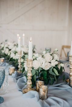 the table is set with candles and flowers