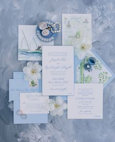 the wedding stationery is laid out on top of each other