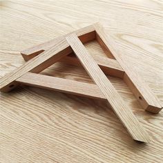 three pieces of wood sitting on top of a wooden table with one piece cut in half