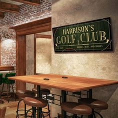 the interior of a golf club with bar stools and wooden tables in front of brick walls