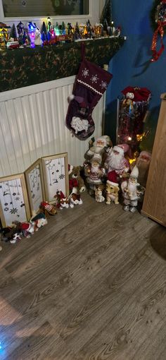 there are many christmas decorations on the floor in this room with santa's stocking