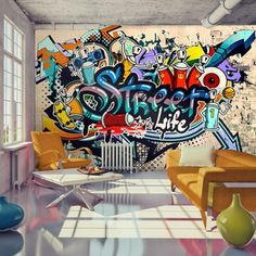 a living room filled with furniture and graffiti on the wall