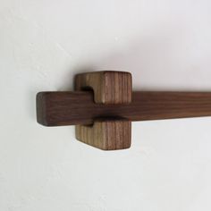 a close up of a wooden handle on a wall