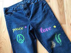 "Upcycled decorated women's size 10 jean capris, embellished handmade painted boho hippie style capris with peace signs, flowers and butterflies along with the words \"peace\" and \"love.\"  Make a statement at your next summer outing with these cute, eye-catching, bohemian festival jean capris! DETAILS: Size:  10 Brand:  Gloria Vanderbilt Materials:  81% cotton, 18% polyester, 1% elastane MEASUREMENTS: Waist:  32 inches Hips:  38 inches Inseam:  21 inches Front Rise:  10 inches Back Rise:  16 inches Circumference bottom of leg:  15 inches Be sure to check the size and measurements.  Sizing for clothing brands is often different! Hint:  To be sure this item will fit, lay your favorite pants/jeans out flat and take measurements of the same areas listed above. These are upcycled jeans, meani Cute Hippie Jeans, Hippie Style Jeans For Summer Festival, Fun Spring Festival Bottoms, Relaxed Fit Jeans For Spring Festival, Handmade Bohemian Bottoms For Spring, Handmade Hippie Bottoms For Spring, Summer Festival Hippie Jeans, Fitted Denim Hippie Bottoms, Hippie Denim Pants