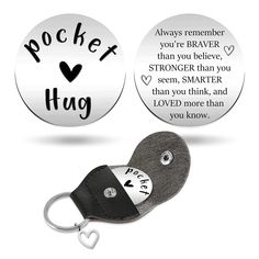 two key chains that say, rocket hug and always remember you're braver than you believe, strongter than smarter than you think, and love more than loved more than you know