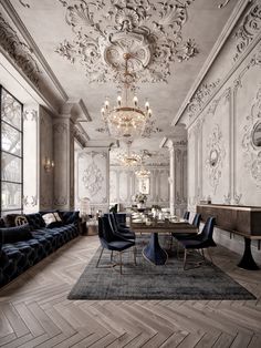 an elegant living room with chandelier and couches in the middle of it