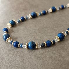 "Lapis Lazuli Bead Necklace Women ☆ Arrives ready for gifting and usually ships same day or next day. The necklace will be sent with a gift! O T H E R ∙ I N F O R M A T I O N Lapis Lazuli size: 8 mm Lapis Lazuli size: 6 mm Sodalite size: 3 mm Clear Quartz size: 3 mm **Intermediate apparatus and beads are non-tarnish gold plated. Length: The length shown on our models are 16\" and 18\" you may select 14-30\" from the drop down menu provided. If you want a size change, please contact us or leave us a message. :) ☆ Each of our necklaces at PEARLOWNJEWELRY are handmade and special natural stones. Necklace is made with positive energy. Each crystal is cleaned before shipment. We update the stock amount according to the custom of stones . If you contact us in case of bulk purchase or no stock, w Lapis Lazuli Beaded Necklace, Elegant Lapis Lazuli Gemstone Beaded Necklaces, Blue Lapis Lazuli Gemstone Bead Necklaces, Elegant Lapis Lazuli Beaded Necklace, Sapphire Lapis Lazuli Beaded Necklace, Blue Stone Necklace, Blue Statement Necklace, Stones Necklace, Green Beaded Necklace