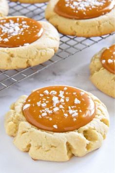 peanut butter cookies cooling on a wire rack with some caramel sauce in the middle