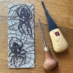 a piece of wood sitting on top of a wooden table next to a pair of scissors