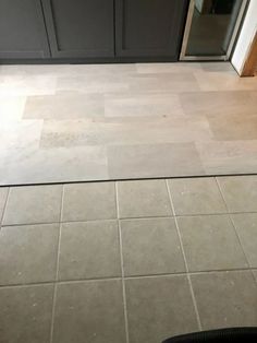 a kitchen floor that has been cleaned and is in the process of being remodeled with tile