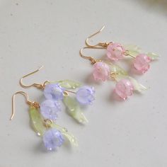 Crafted from shrink plastic, these earrings feature delicate lily of the valley flowers in light blue and light pink. Their gentle and lovely design adds a touch of elegance to your style. Embrace the charm of nature with our Lily of the Valley Earrings. M A T E R I A L S * A N D * S I Z E  - Length: 35mm - Width: 25mm Available in Gold Finish!  Ear Wires: 925 sterling silver Cheap Light Blue Flower Earrings For Gift, Clothes Made From Nature, Cute Earring Ideas, Shrinking Plastic Earrings, Lily Of The Valley Earrings, Baby Blue Earrings, Fairy Jewellery, Pink Earring, Anting Manik