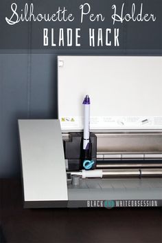 the silhouette pen holder blade hack is on top of a desk next to a printer