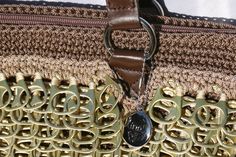 a close up of a purse with metal handles