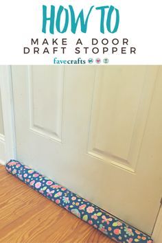 a door stopper sitting on the floor next to a white door with blue and pink flowers