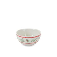 a white bowl with red trim and holly designs on the rim, against a white background