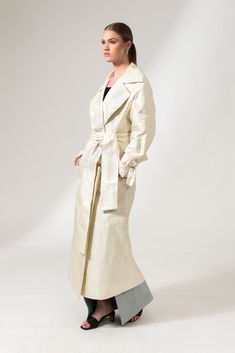 The Mae Trench Coat is a reinvented bold twist on the classic Mary Trench Coat. Crafted from pure jacquard silk, it is a double-breasted coat that comes in a relaxed fit with wide lapels, collar, and sleeves. It's elevated through its minimal interwoven matte-finished chequered pattern, fluid shape, and French seams. This sustainable trench coat is tailor made and on demand and takes us 10 hours to make it. PLEASE ALLOW 1-5 BUSINESS DAYS FOR PRODUCTION Spring Formal Jacquard Outerwear, Luxury Silk Double-breasted Outerwear, Formal Spring Jacquard Outerwear, Chic Silk Outerwear For Daywear, Luxury Silk Long Coat Outerwear, Chic Silk Double-breasted Outerwear, Luxury Silk Outerwear For Spring, Chic Fall Jacquard Outerwear, Cream Silk Outerwear For Fall