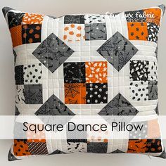 the square dance pillow is made with black and orange squares