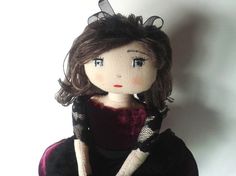 a doll is dressed in black and red