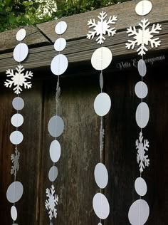 an image of snowflakes hanging from the side of a wooden fence with text overlay