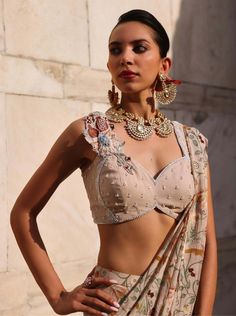 Step into elegance with this embellished choli adorned with delicate appliqué detailing on the neckline, perfectly paired with a printed draped sari. This ensemble effortlessly combines intricate craftsmanship with vibrant prints, offering a fusion of traditional charm and contemporary allure. Ideal for weddings, receptions, or cultural festivities, it promises to captivate attention and leave a lasting impression. Embrace effortless glamour and showcase your unique style with this exquisite out Weddings Receptions, Vibrant Prints, Blush Pink, Unique Style, Blush, Weddings, Pink