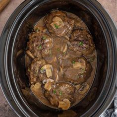 meatballs and mushrooms are cooked in the slow cooker