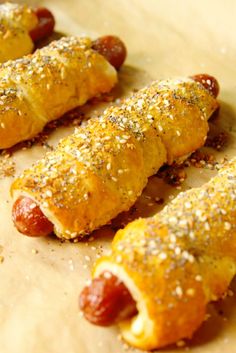 hotdogs wrapped in bread and sprinkled with sesame seeds