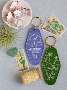 some stamps are laying on a table next to an air plant and a rubber keychain