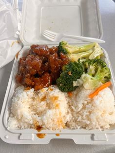 a plastic container filled with rice, broccoli and other food on top of a table