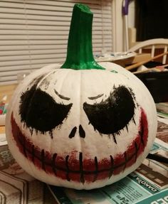 a painted pumpkin sitting on top of a table