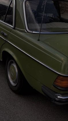 an old car parked on the side of the road