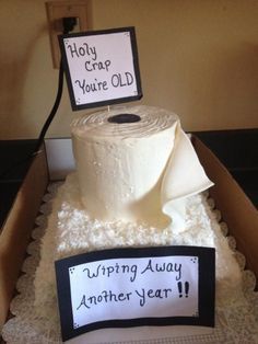 a birthday cake made to look like it has two rolls of toilet paper on top