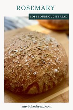 a loaf of bread sitting on top of a wooden cutting board with the words rosemary soft sourdough bread