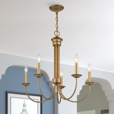 a chandelier hanging from the ceiling in a room with blue walls and white trim