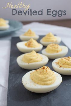 deviled eggs are arranged on a slate board with the words healthy deviled eggs written above them