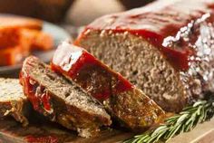 meatloaf on a white plate with ketchup