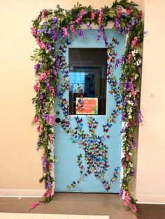 a blue door decorated with flowers and butterflies