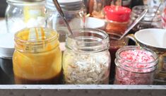 several jars filled with different types of food