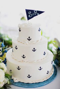 there is a wedding cake with an anchor on it