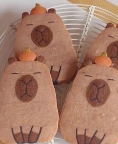 some cookies shaped like bears with pumpkins on them