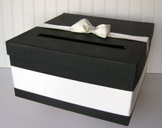 a black and white box with a bow on top