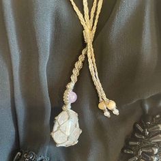 Create more love and joy with this beautiful Macrame Crystal Gemstone Necklace. This beautiful necklace is handcrafted using Aura Rose Quartz Crystal. This necklace is adjustable and can be worn long, short, or in between. It is hand knotted, braided, and fitted to its unique stone and made with a strong, smooth waxed Charcoal Cord. Aura Rose Quartz is Rose Quartz that is bonded with precious metals to create a beautiful rainbow aura effect. Aura Rose Quartz opens the heart and mind to new oppor Artisan Necklace With Adjustable Cord For Healing, Rose Quartz Gemstone Necklaces For Meditation, Spiritual Necklace With Adjustable Cord, Rose Quartz Gemstone Necklace For Meditation, Handmade Adjustable Moonstone Beaded Necklace, Adjustable Spiritual Rose Quartz Necklaces, Handmade Rose Quartz Spiritual Necklace, Adjustable Rose Quartz Crystal Necklace For Healing, Adjustable Amethyst Crystal Necklace For Meditation