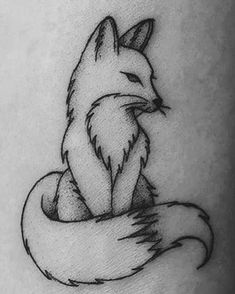 a small fox tattoo on the arm